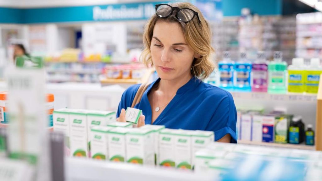 Femme qui consulte des produits en pharmacie