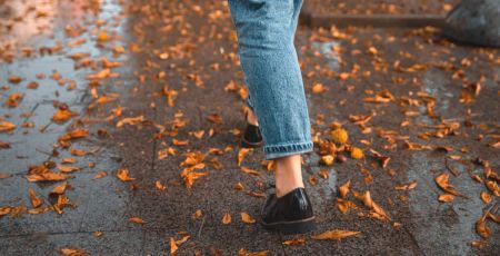 Femme qui marche dans les feuilles d'automne